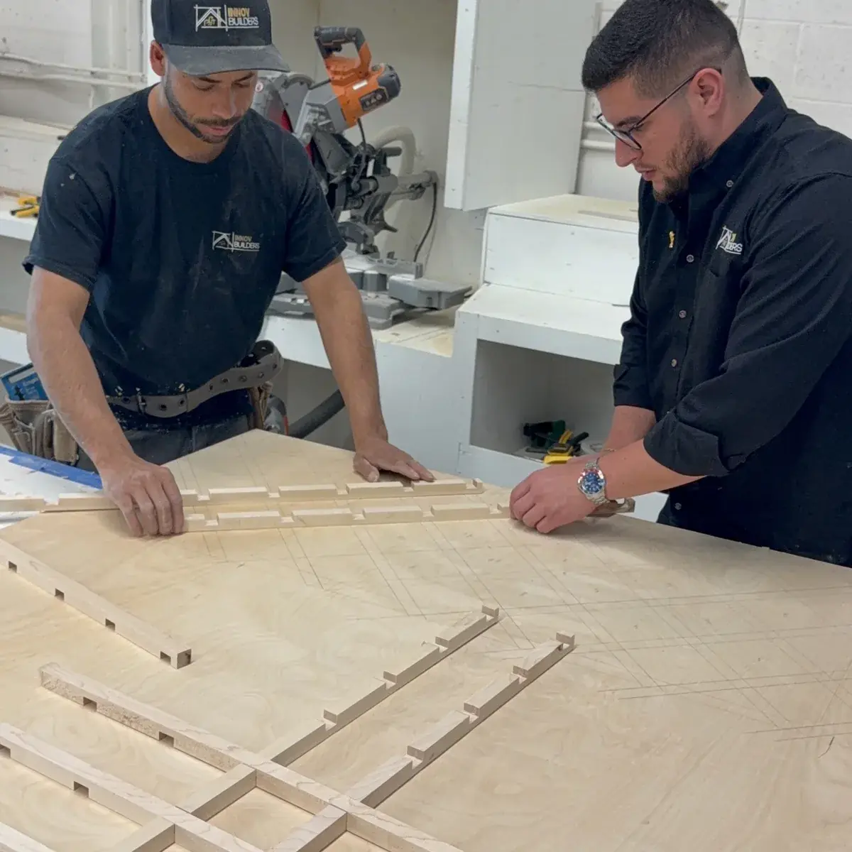 Innov Builders craftsmen assembling custom built-in cabinets in their shop