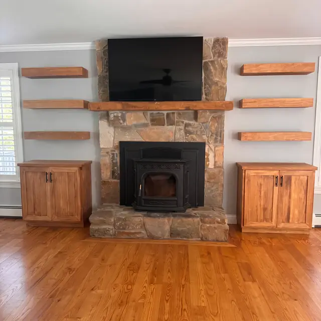 Fireplace built-ins with wood cabinets and floating shelves