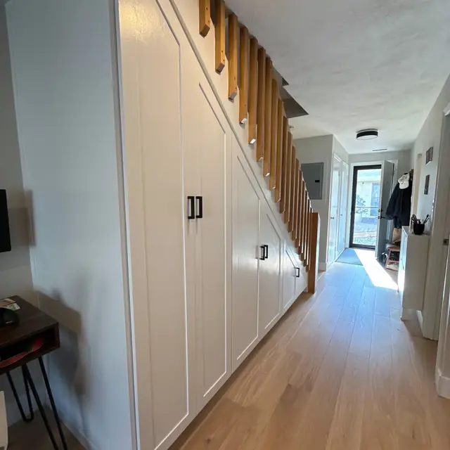 Built-in under-stair storage along a hallway